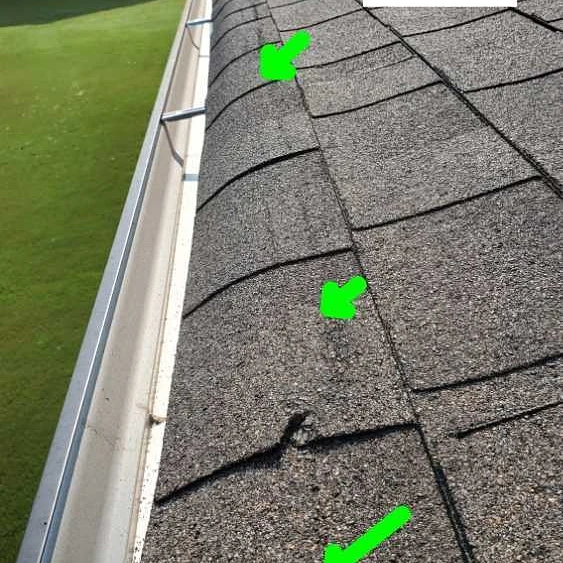 Shingles are damaged from wind or installation. Home Inspection by Powerworks Inspections