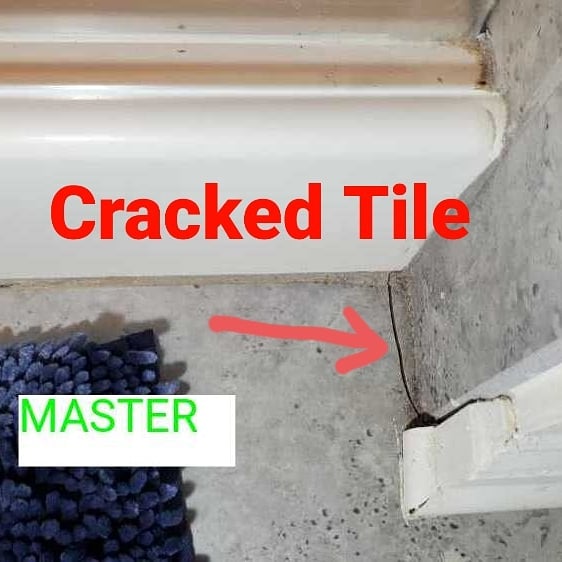 Crack bathroom tile. Home inspection by Powerworks Inspectons