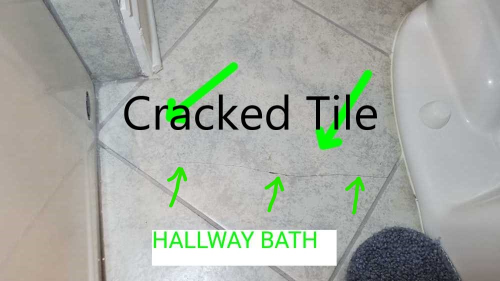 Bathroom tiles cracked from initial settling of building. Noted during a home inspection by Powerworks Inspections