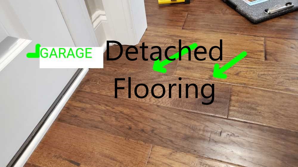 Flooring is detached from slab. Noted by Powerworks Inspections during a 11 Month warranty inspection.