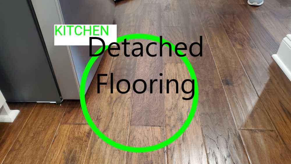 Flooring is detached from slab. Noted by Powerworks Inspections during a 11 Month warranty inspection.